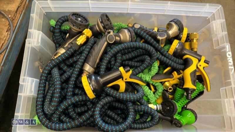 Box of expandable garden hoses, spray guns