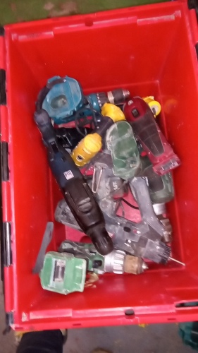 Box of various cordless power tools