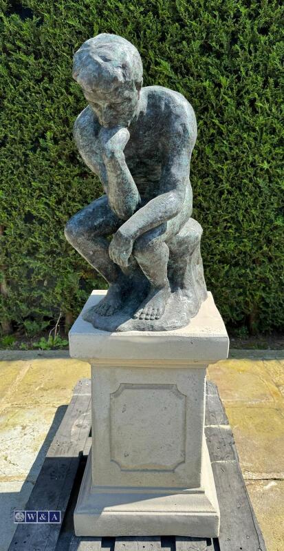 Bronze statue of ''the thinker by Auguste Rodin gates of hell paris'' on cast stone plinth